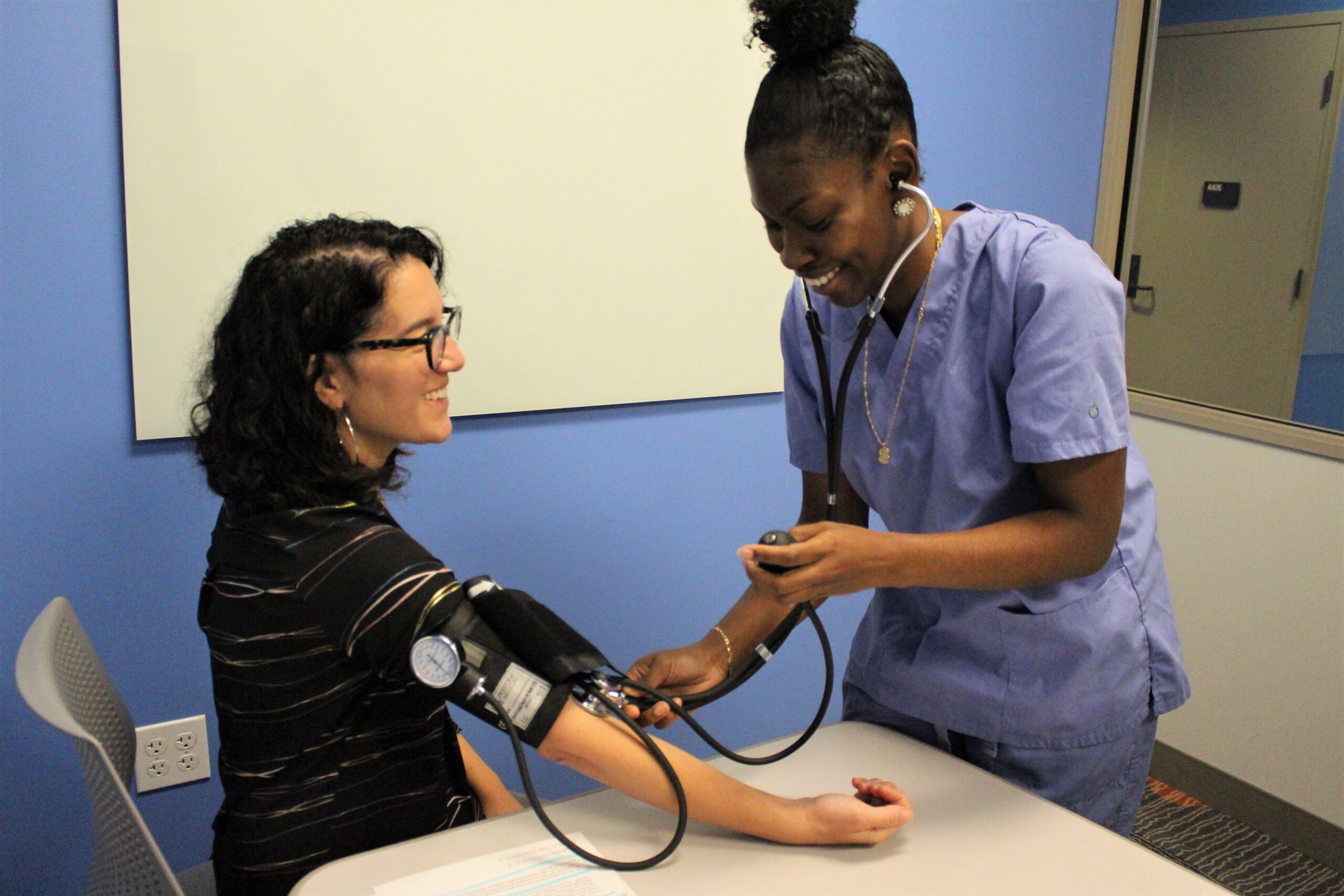 medical assistant taking blood pressure