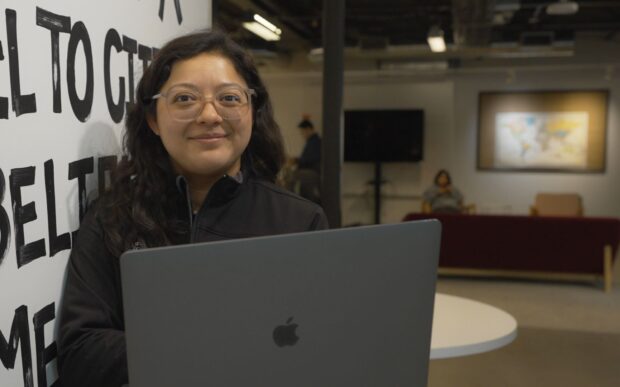 Woman with a computer smiling