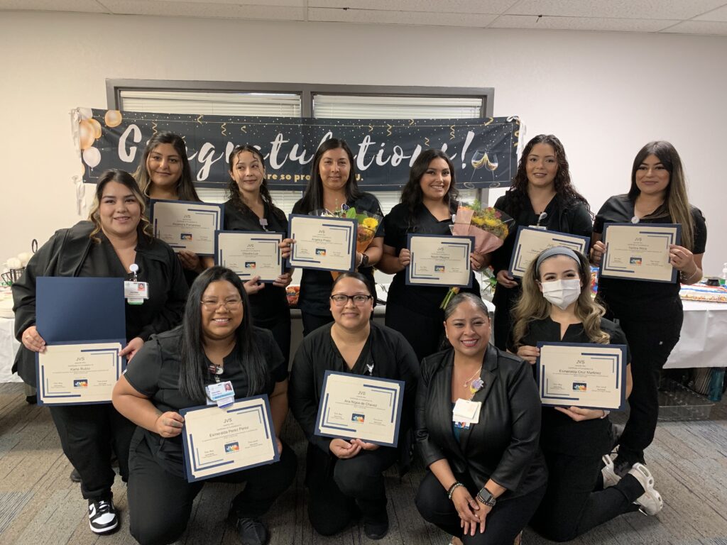 Graduates from a Central Valley Health Network and JVS training program smile and show their certificates