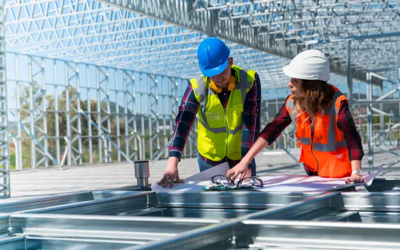 Two people in hard hats at a power plant