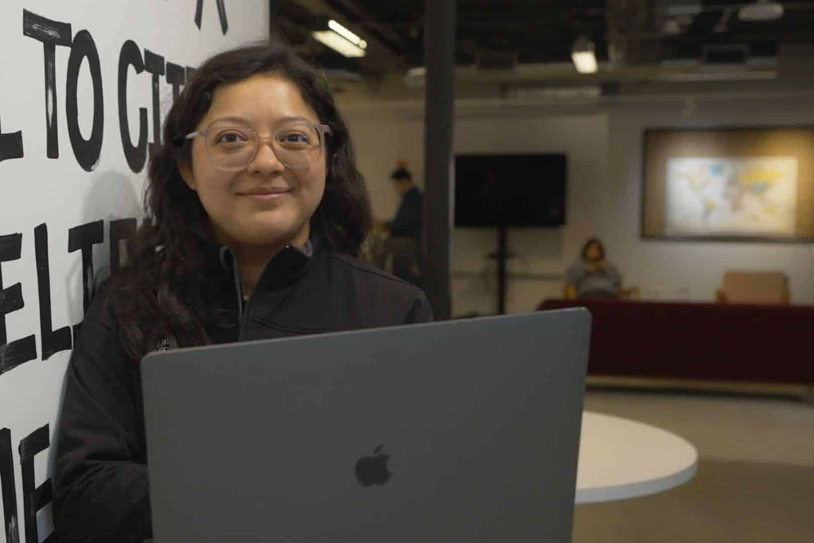 Woman with a computer smiling